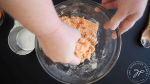 Kneading complete protein pasta dough in a glass mixing bowl.