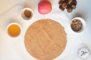 All the individual ingredients for this Fig Galette Recipe on a white surface.