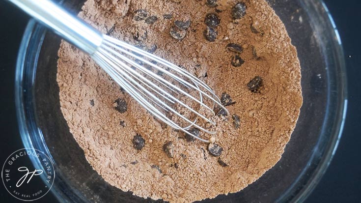 Chocolate chips stirred into a dry flour mixture for Cauldron Cakes.