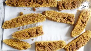 Once baked biscotti pieces laying on a cookie sheet for their second baking.