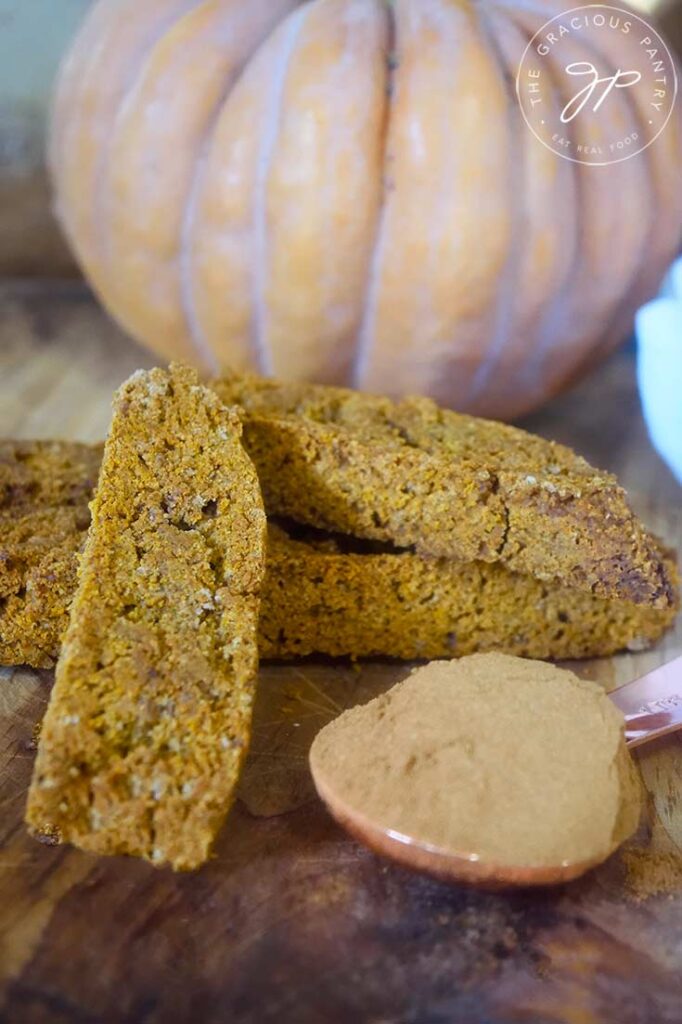 A close up of Gluten-Free Pumpkin Biscotti on a wooden surface.