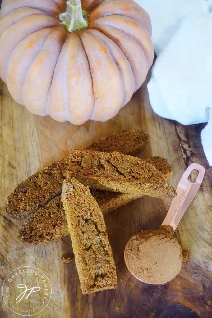 An overhead view looking down at Gluten-Free Pumpkin Biscotti laying on a wooden surface.