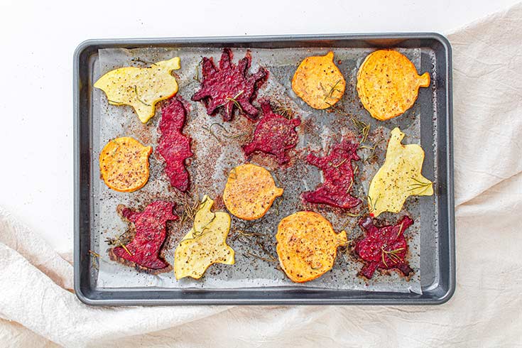 Halloween Roasted Vegetables cooling on a sheet pan after roasting.