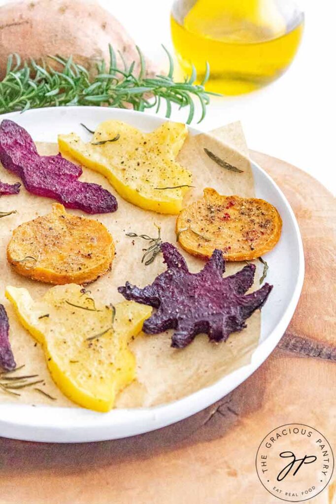 A side view of a plate holding differently shaped Halloween Roasted Vegetables.