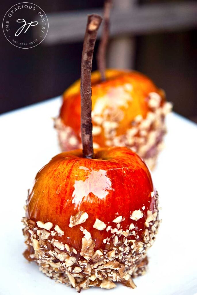 Two Healthy Candied Apples on a white platter.