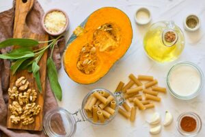 Pumpkin Pasta Recipe ingredients gathered on a white countertop.