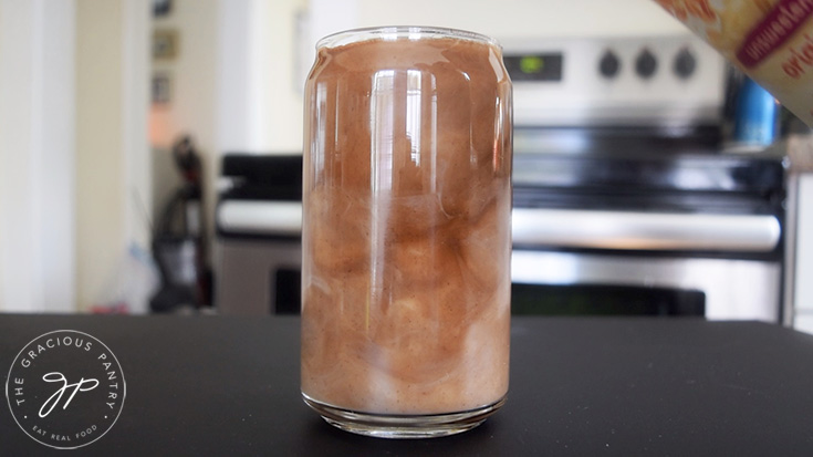 Pouring milk into the Pumpkin Spice Cold Brew Coffee.