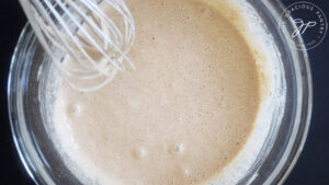 Whisked Pumpkin Spice Pancake batter in a mixing bowl.