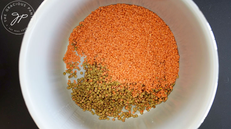 Red and brown lentils in a slow cooker crock.