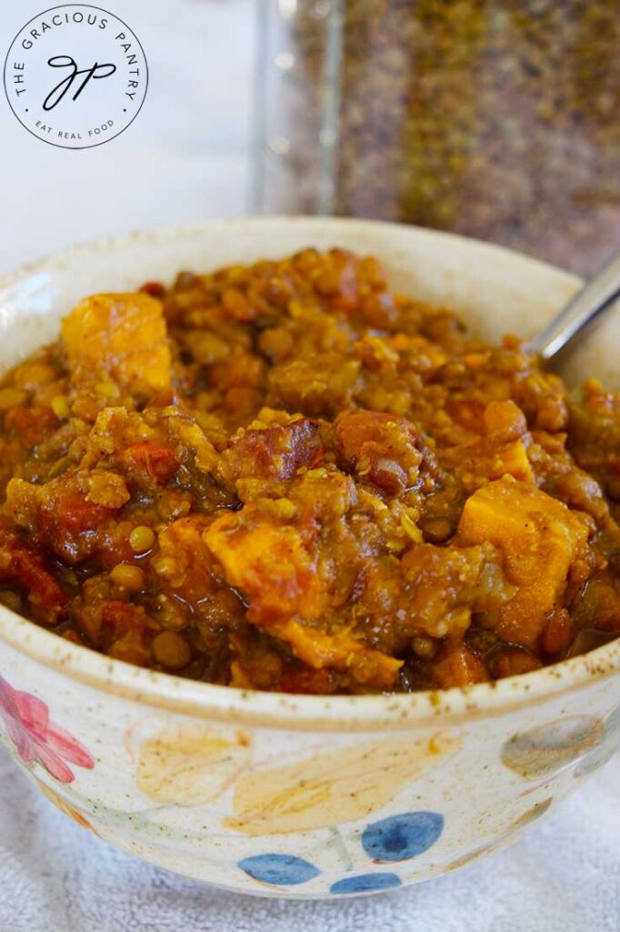 A ceramic bowl filled with Slow Cooker Lentil Stew.