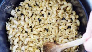 Spreading pasta in a single layer in an air fryer.