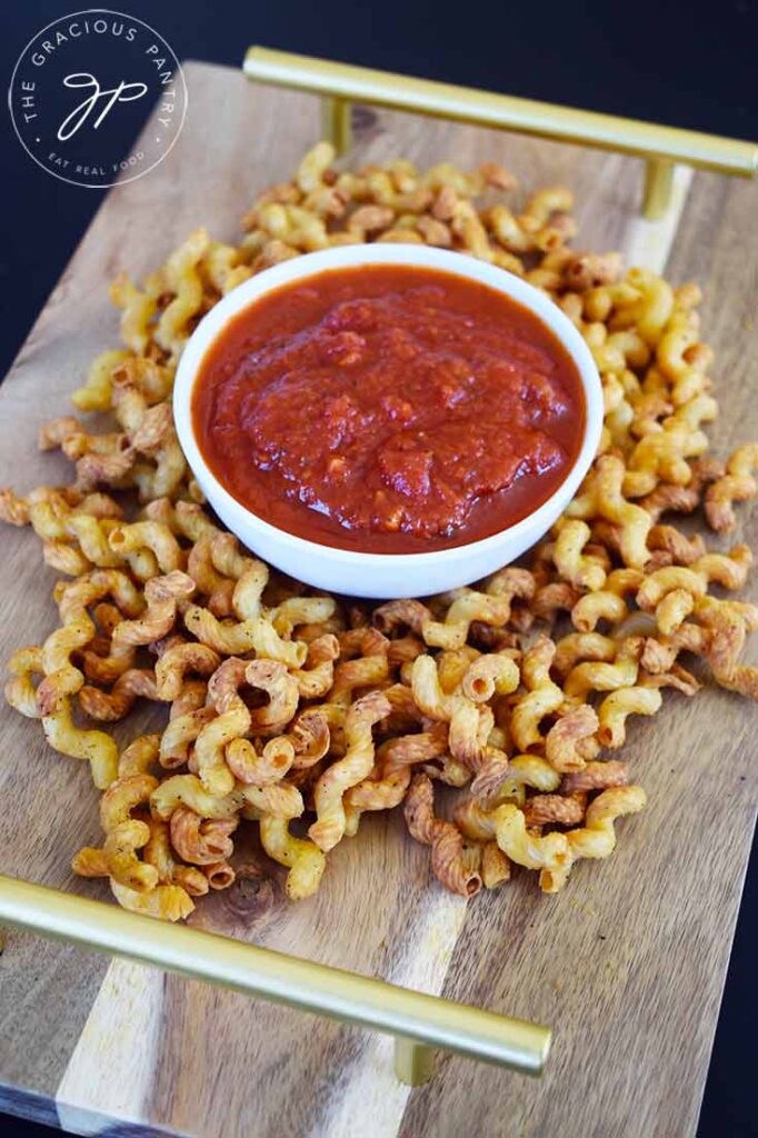 An overhead view of Air Fryer Pasta Chips surrounding a white bowl of marinara.