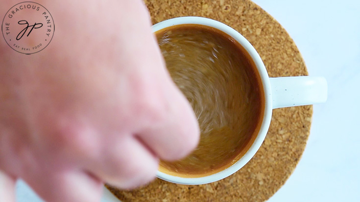 Stirring up a Coconut Latte in a cup.