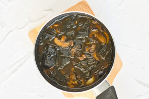 The finished homemade fish sauce, unstrained, sitting in a pot.