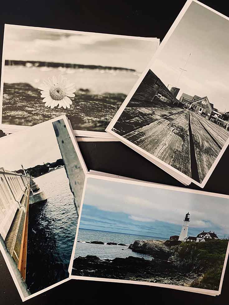 A closeup of 4 photo notecards with various photos of Maine on them.