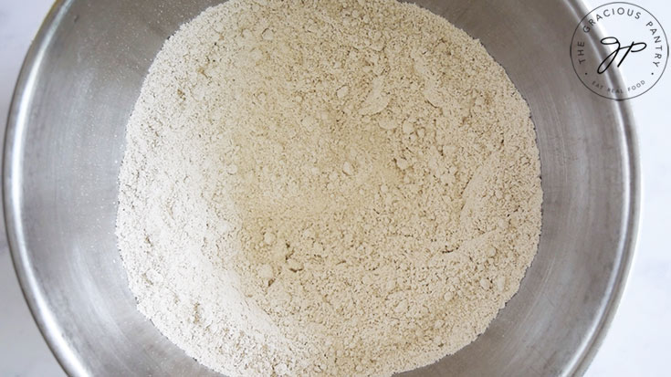 Flour and dry ingredients mixed together in a mixing bowl.