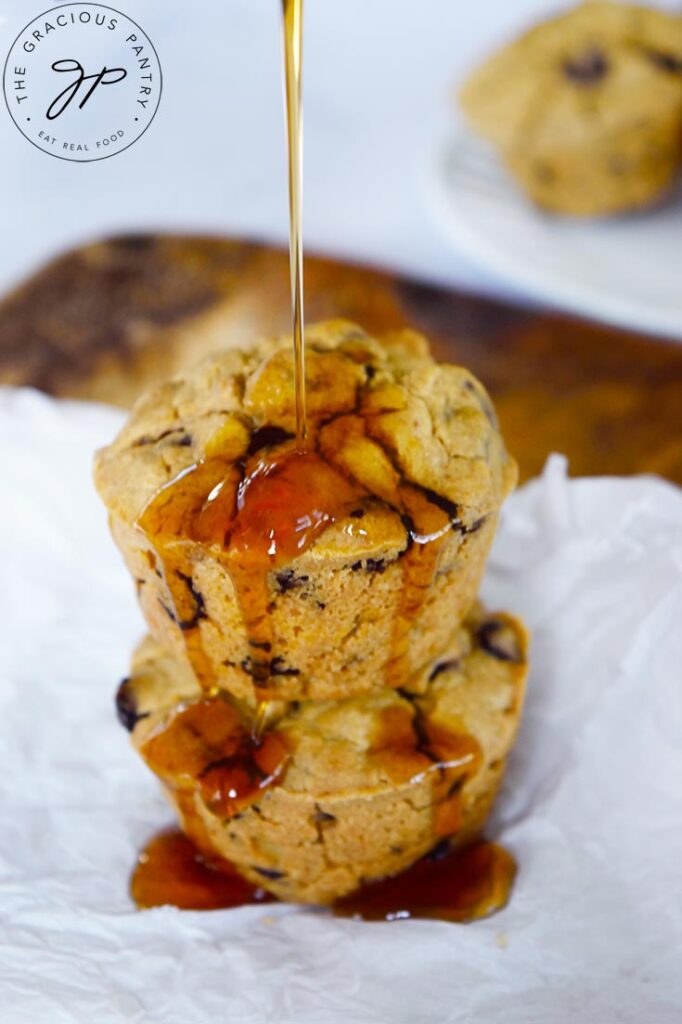 Maple syrup being poured over a stack of two Pancake Muffins.