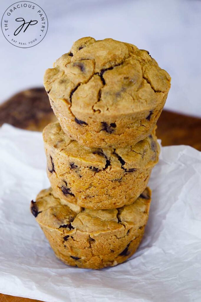 A stack of three Pancake Muffins on a piece of white parchment paper.