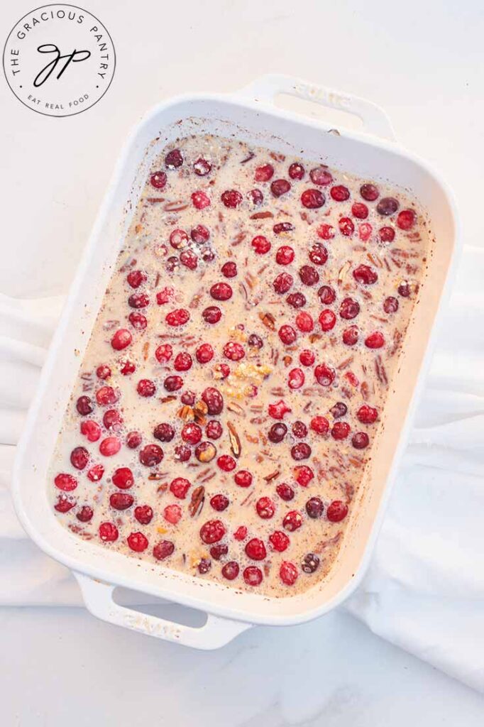 Pumpkin Baked Oatmeal Recipe ingredients combined in a white casserole dish.