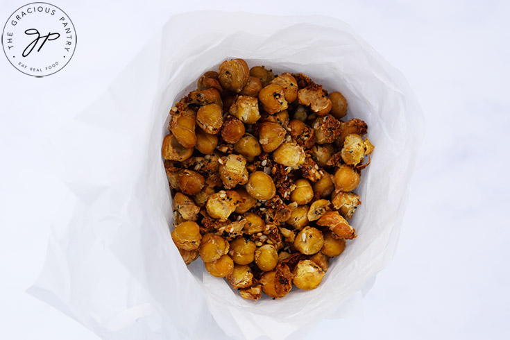 An overhead view of Roasted Everything Bagel Chickpeas in a parchment paper cone.