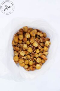 An overhead view looking down into a parchment cone filled with Roasted Everything Bagel Chickpeas.