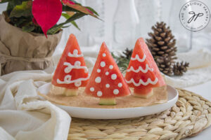Three Watermelon Christmas Trees standing upright on a platter.
