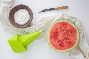 All th needed items for this Watermelon Christmas Trees Recipe on a white work surface.