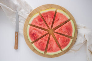 A round slice of watermelon cut into 8 triangles.