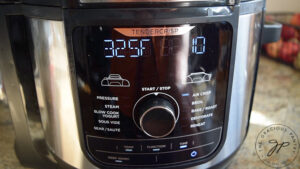 Air fryer display set to proper temperature and time.