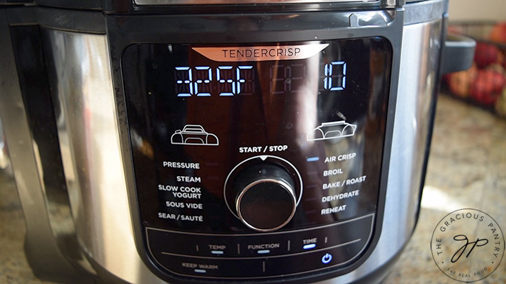 Air fryer display set to proper temperature and time.
