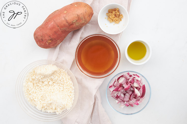 Cauliflower Sweet Potato Mash Recipe ingredients gathered on a white background.