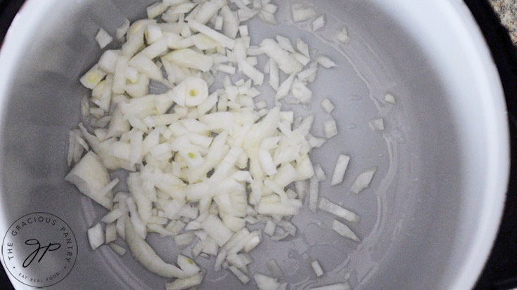 Onions sautéing in a pot.