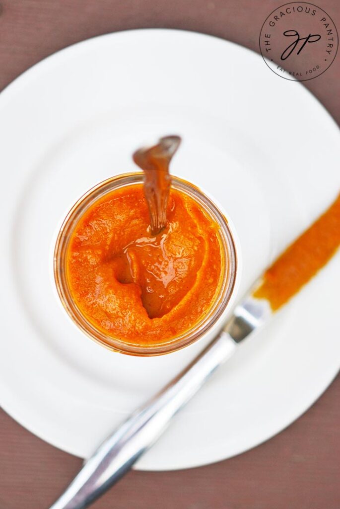 An overhead view looking down into a glass jar filled with Sweet Potato Butter.