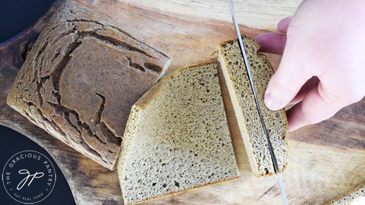 Cutting a second slice lengthwise from a loaf of chicken bread.