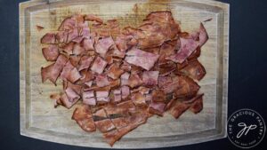 Chopped bacon on a cutting board.
