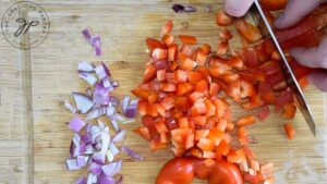 Chopping a red bell pepper.