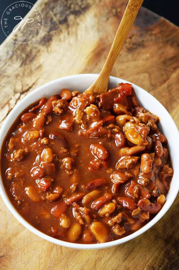 And overhead view of a white bowl filled with Slow Cooker Cowboy Beans.