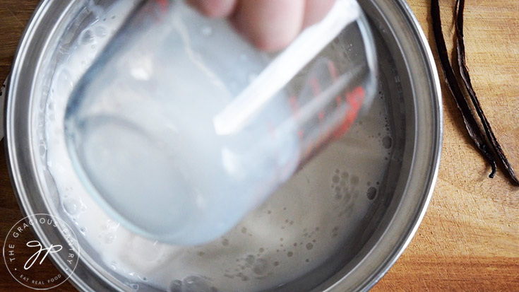 Pouring milk into a pot.