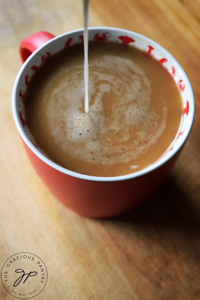French vanilla coffee creamer pouring into a cup of coffee.