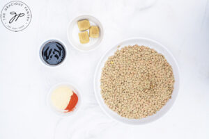 German Lentil Soup Recipe ingredients in white bowls on a white background.