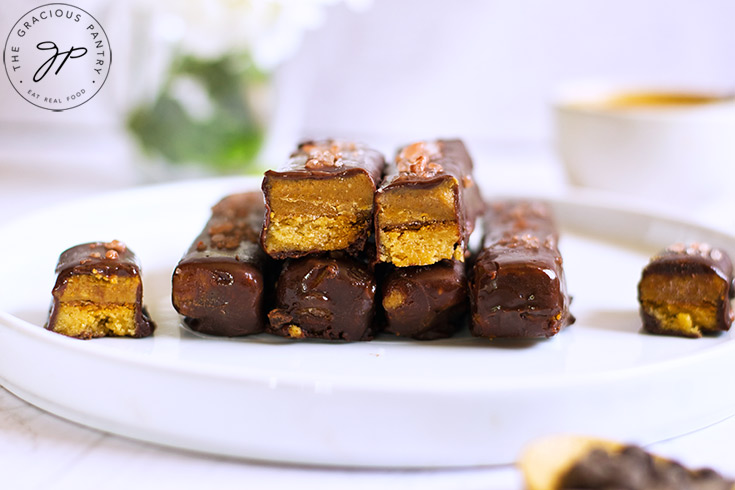 A side view of Healthy Twix Bars on a white plate.