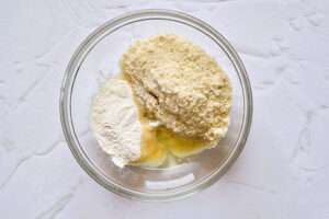 A mixing bowl filled with two different flours.