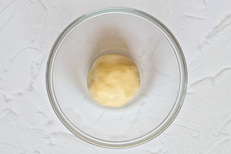 A ball of Healthy Twix Bars dough in a mixing bowl.