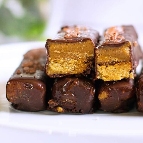 A close up of a stack of Healthy Twix Bars. Two have been cut open to show the inside.