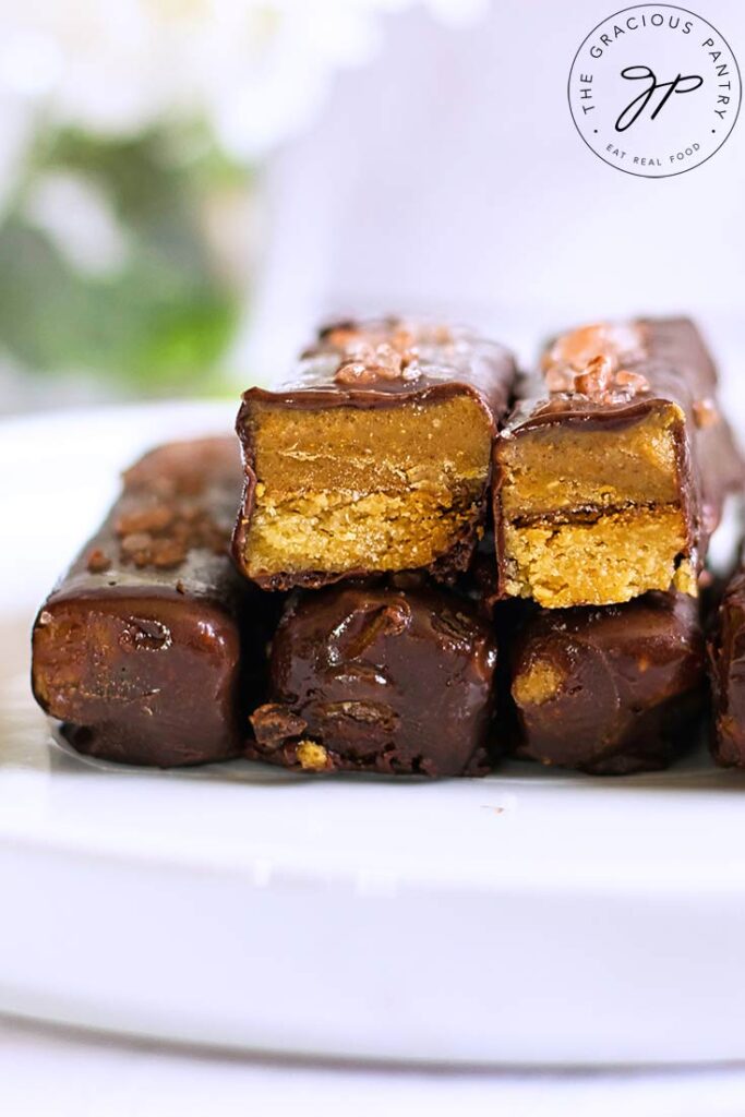 A close up of a stack of Healthy Twix Bars. Two have been cut open to show the inside.