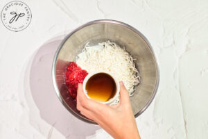 Adding maple syrup to the Raspberry Coconut Truffles filling.