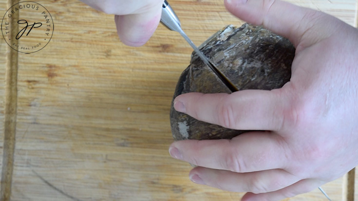 Cutting a rutabaga in half.