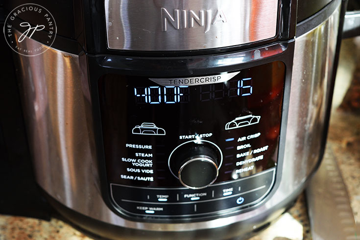An air fryer display panel showing a cooking temperature of 400 degrees F. and a cooking time of 15 minutes.