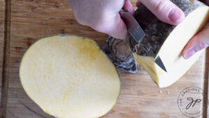 Peeling a rutabaga.