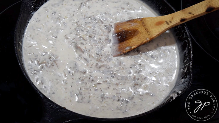 A creamy garlic mushroom pasta sauce in a skillet.